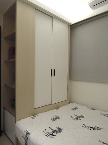 孩臥床尾的延伸就是衣櫃與書櫃，這是經常運用在小空間的收納法。